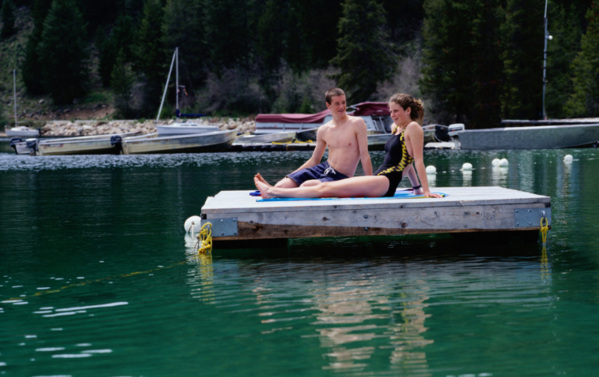 couple sitting on a floating dock